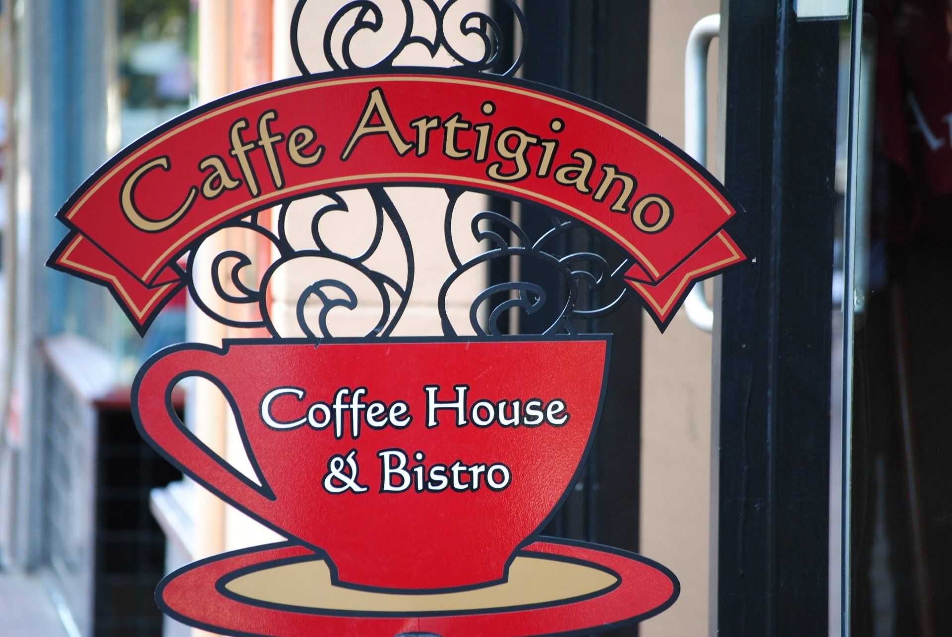 A sign for caffe artigiano coffee house and bistro