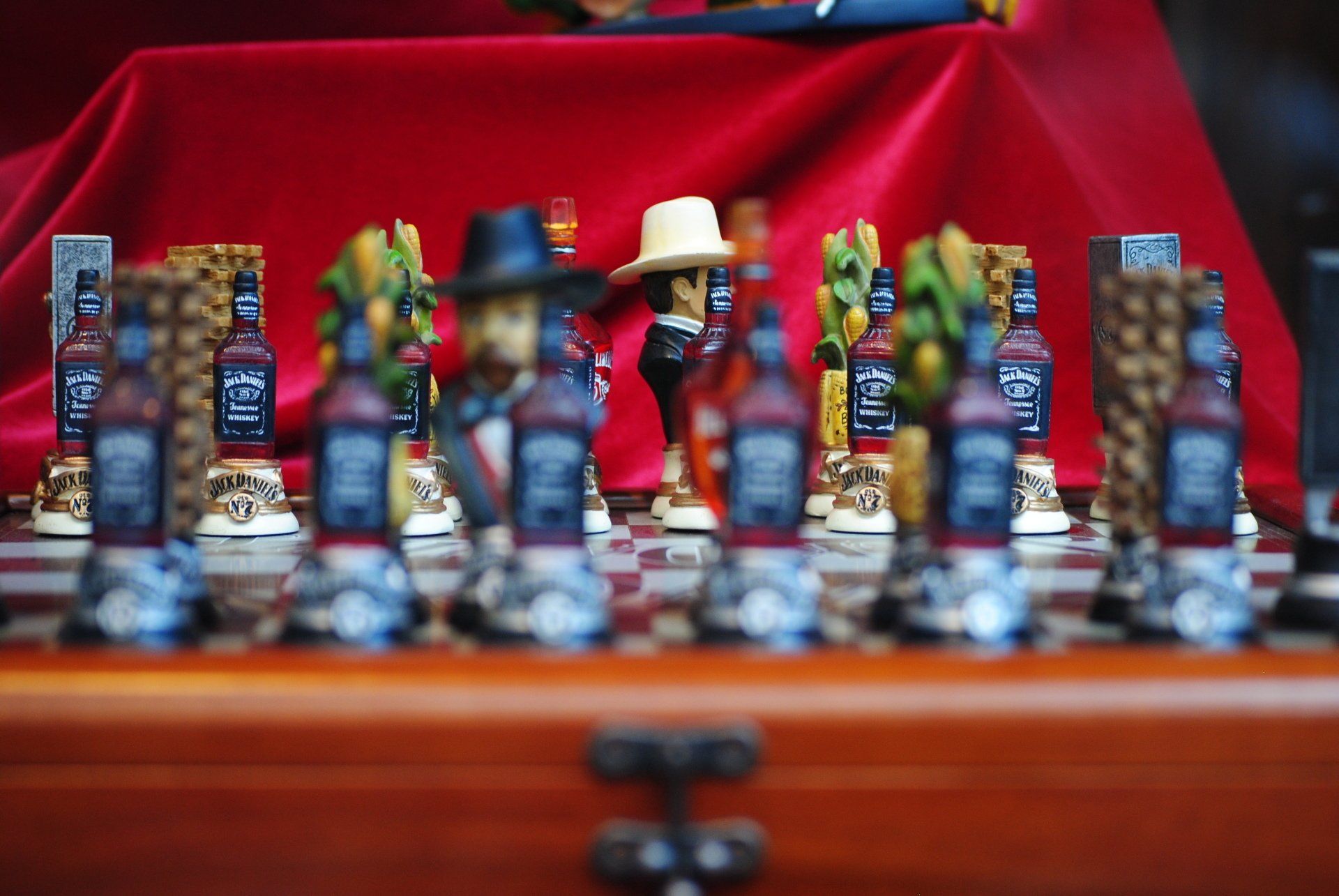 A chess board with bottles of jack daniels on it
