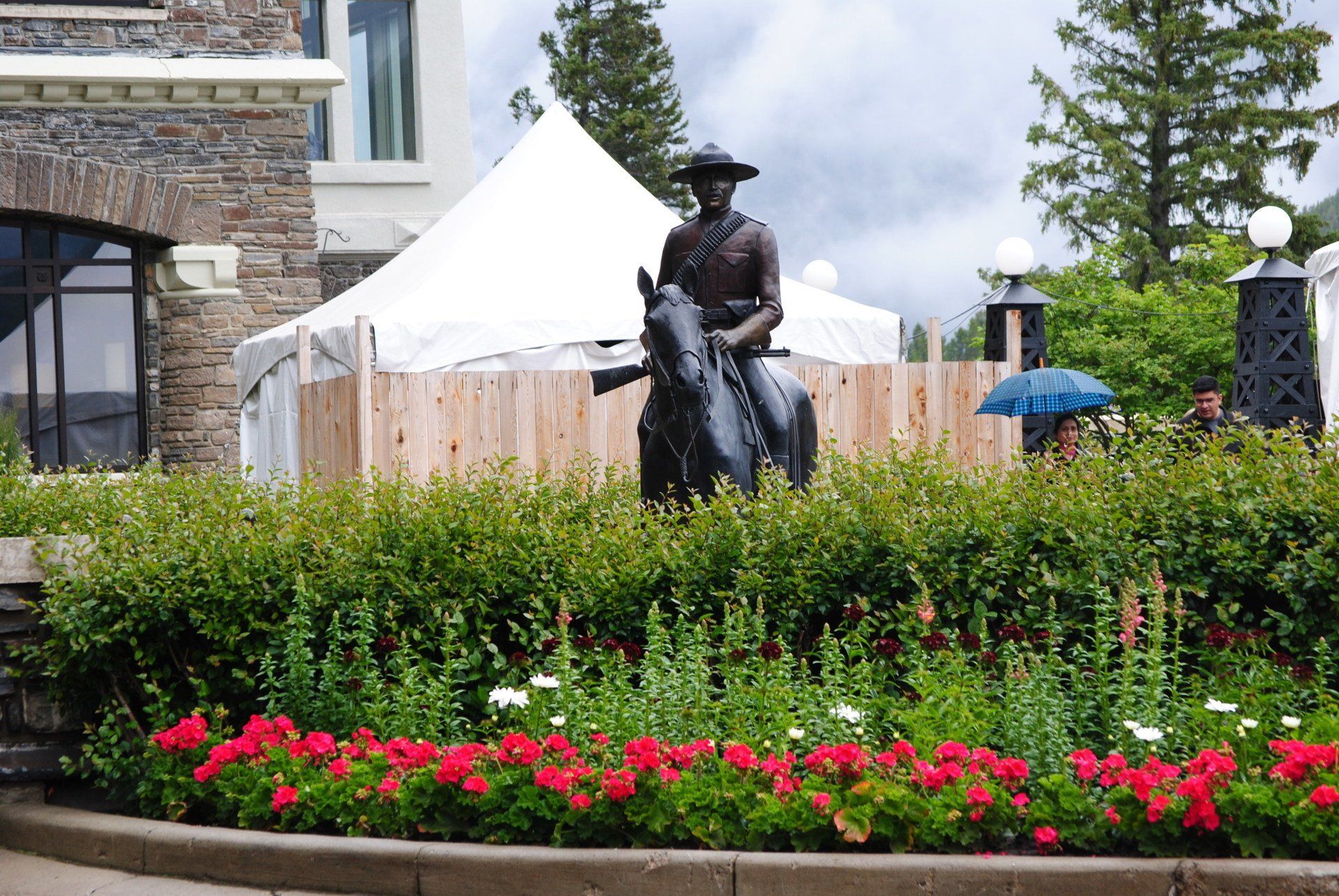 A statue of a man riding a horse in a garden