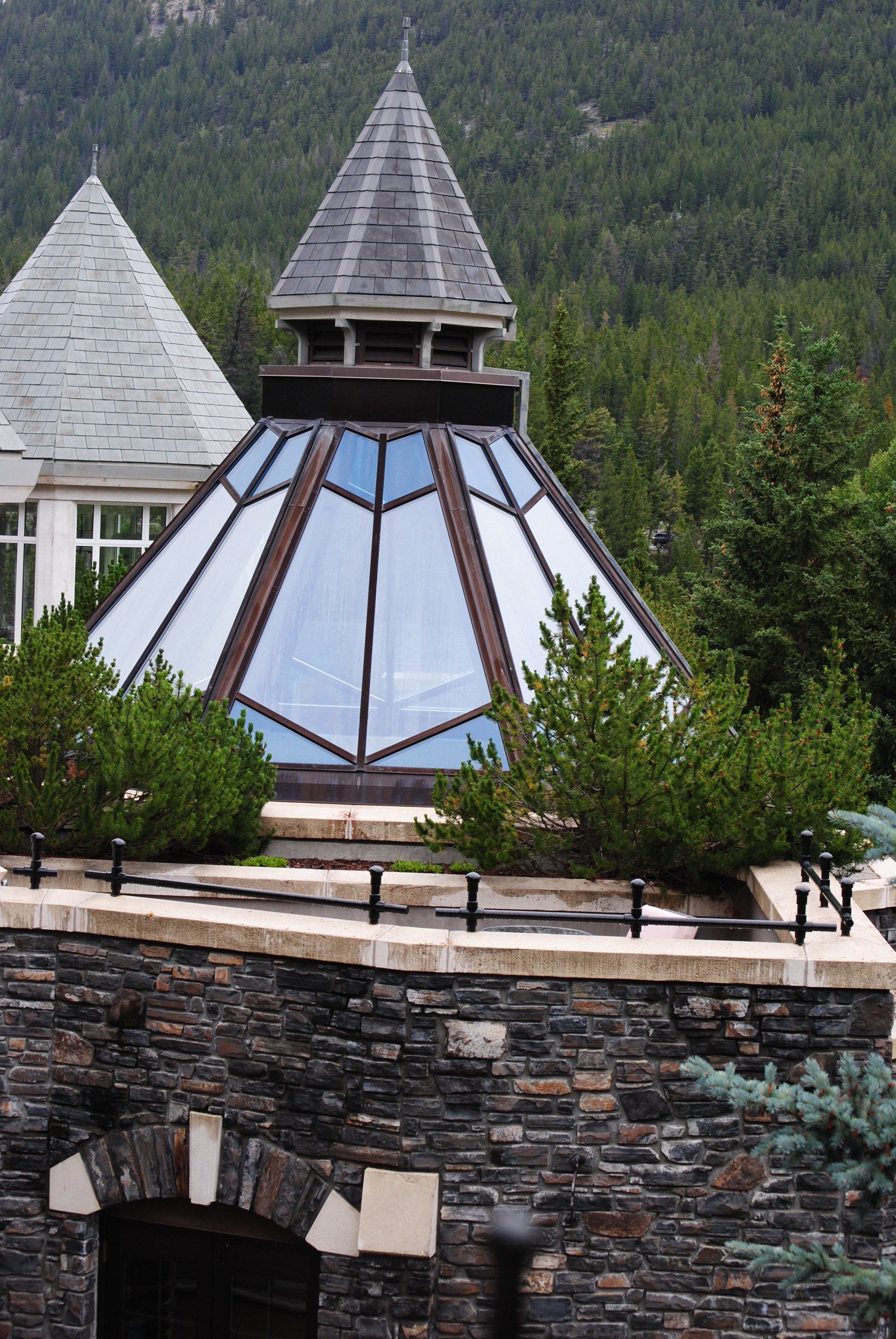 A pyramid shaped building with trees in the background