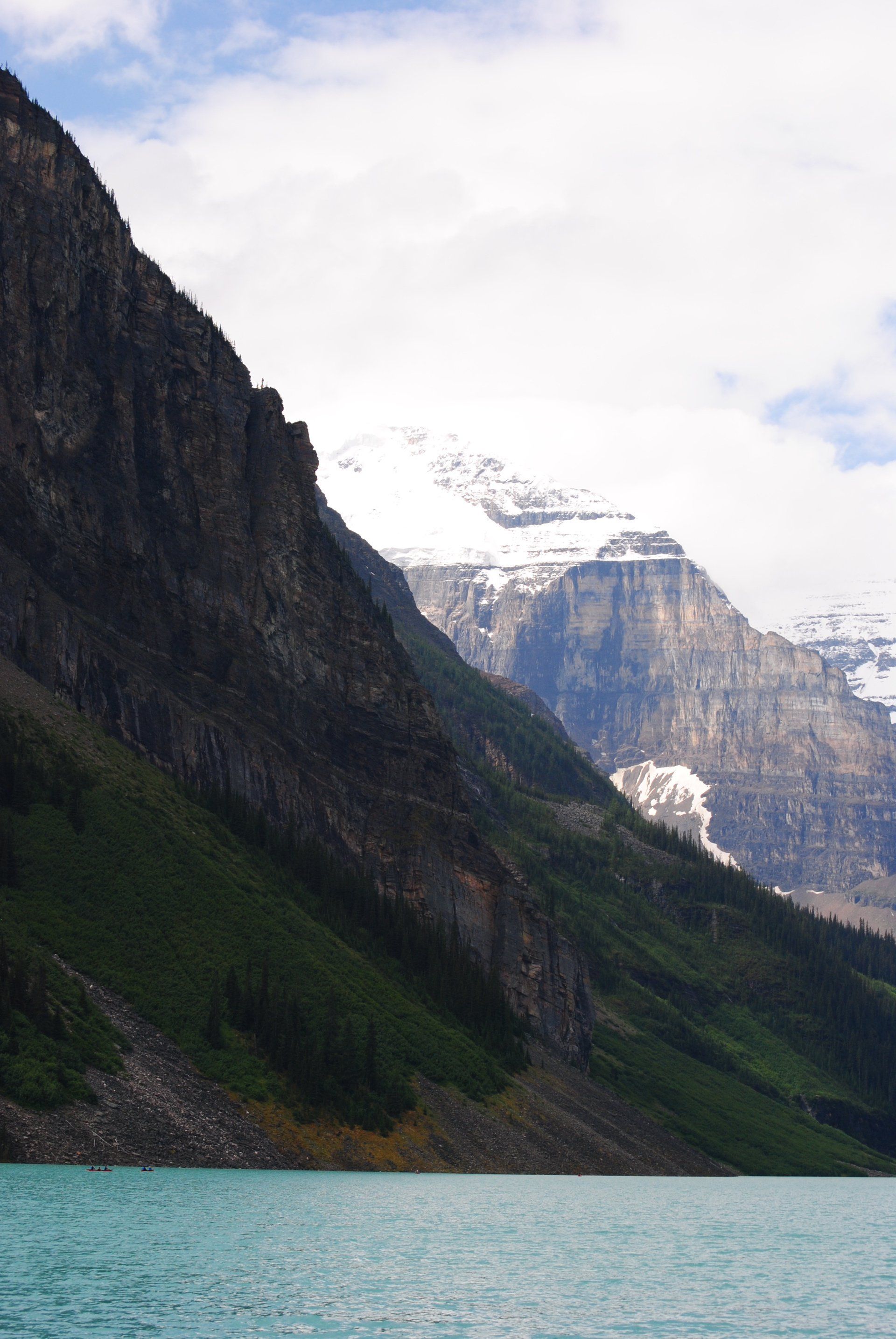A lake with mountains in the background and trees on the shore