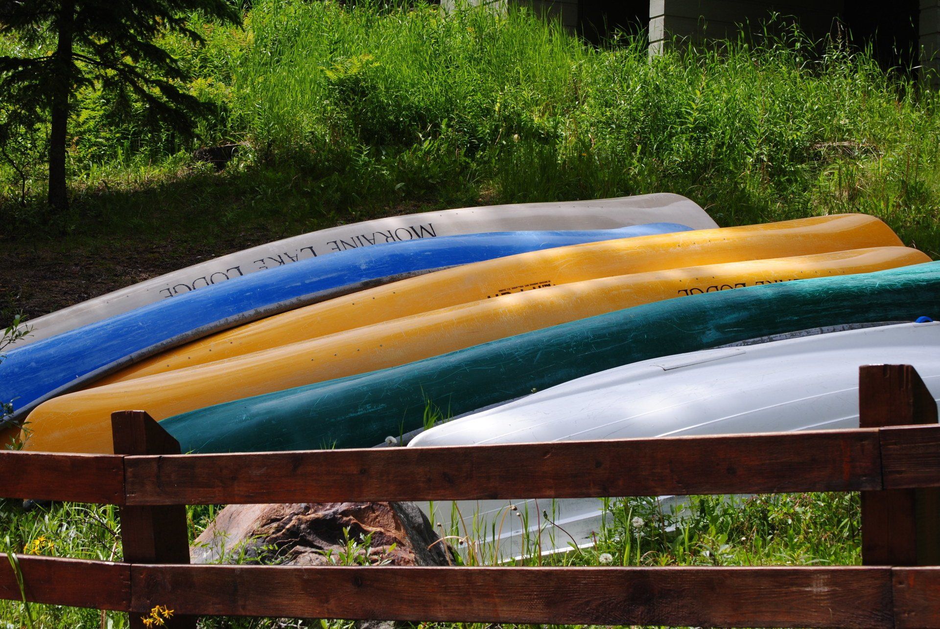 A bunch of canoes are stacked on top of each other