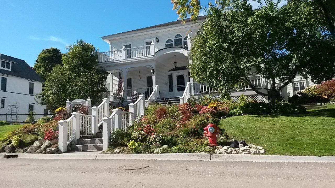 A large white house with a fire hydrant in front of it.