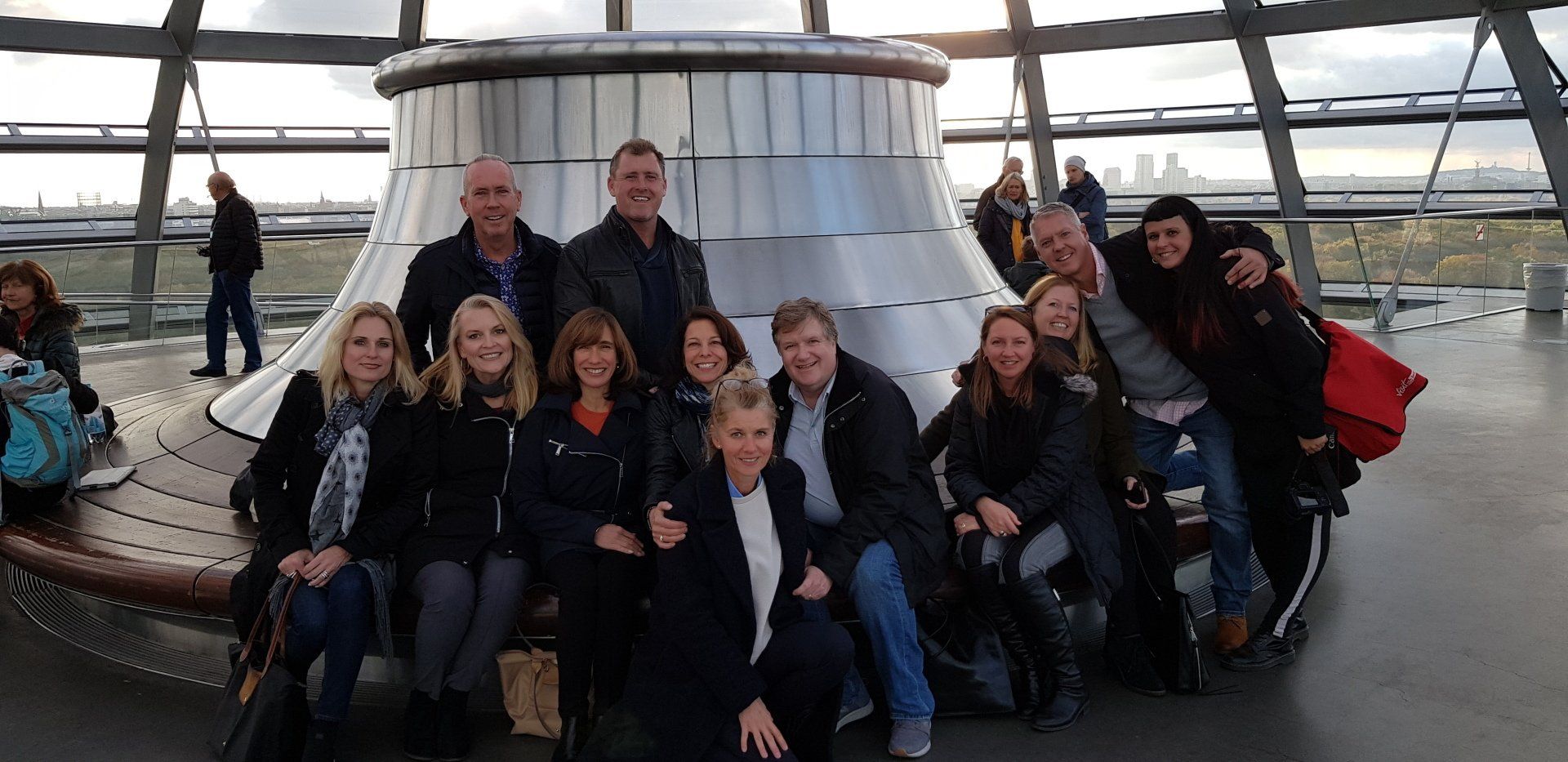 A group of people are posing for a picture in front of a building.