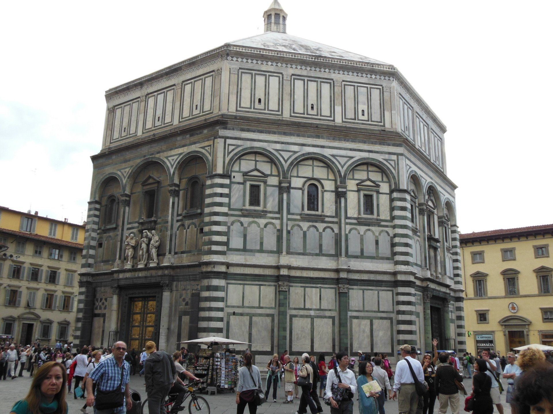 A group of people are standing in front of a large building.
