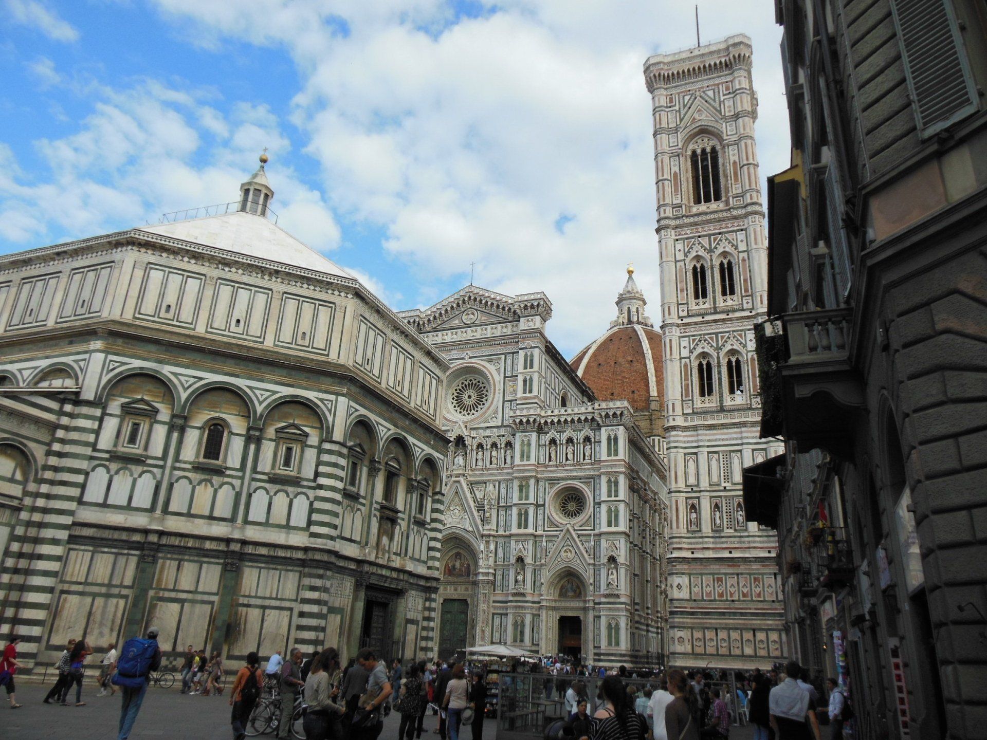 A group of people are walking in front of a large building