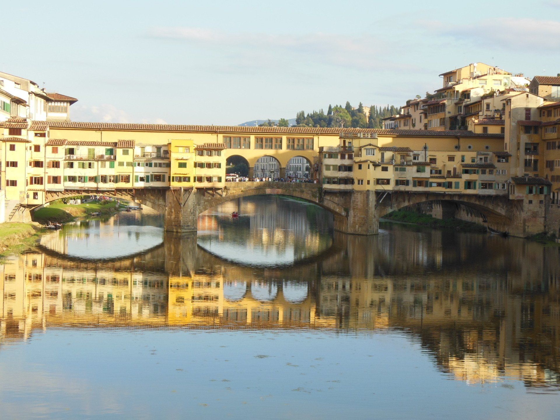 A bridge over a body of water with buildings in the background