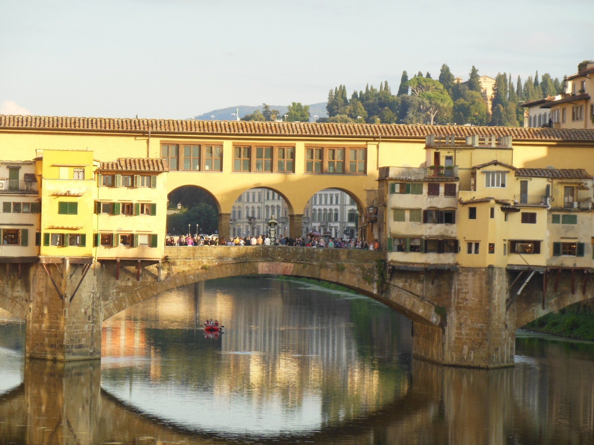 A bridge over a body of water with buildings in the background