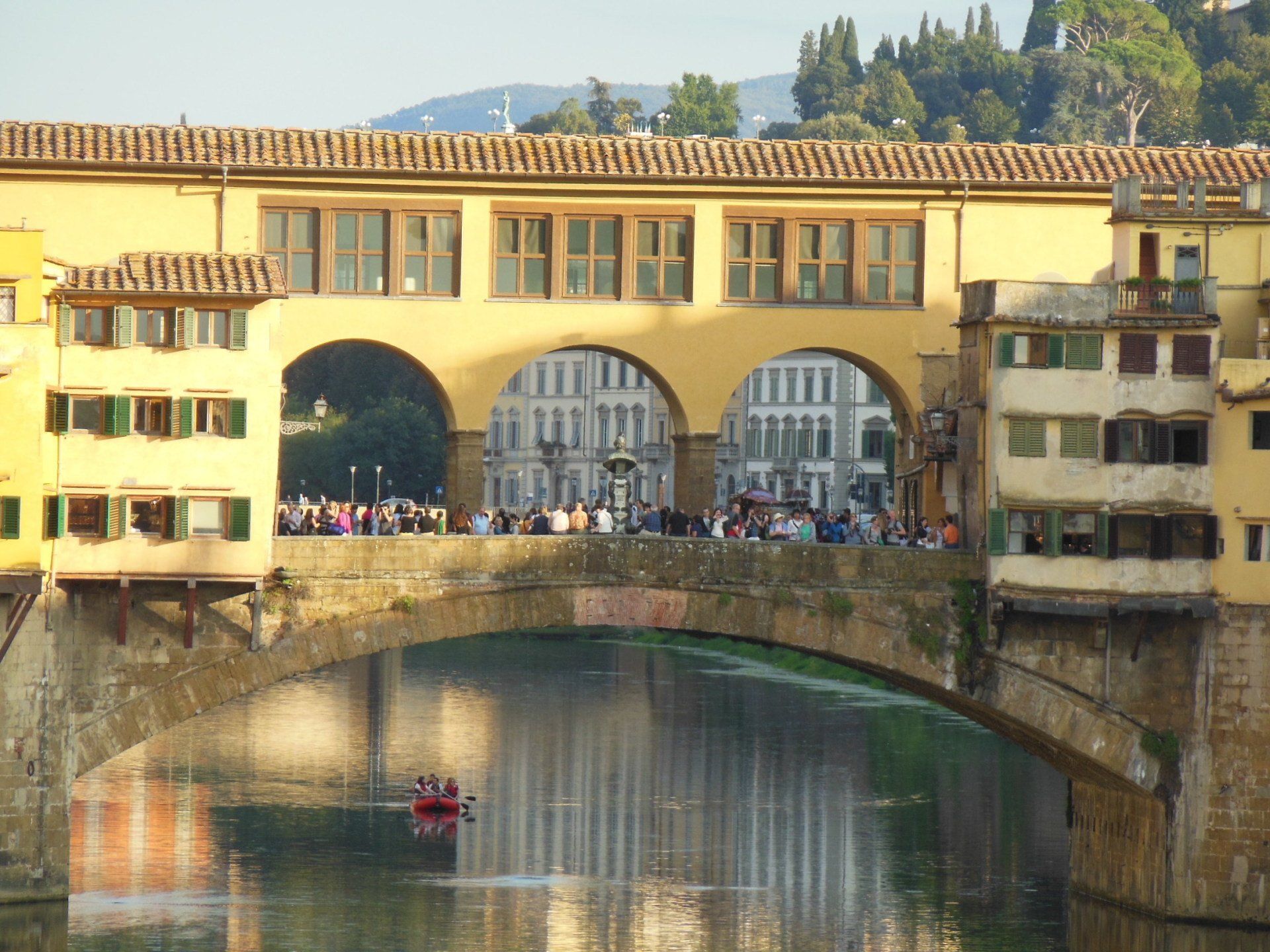 A bridge over a river with a boat going underneath it