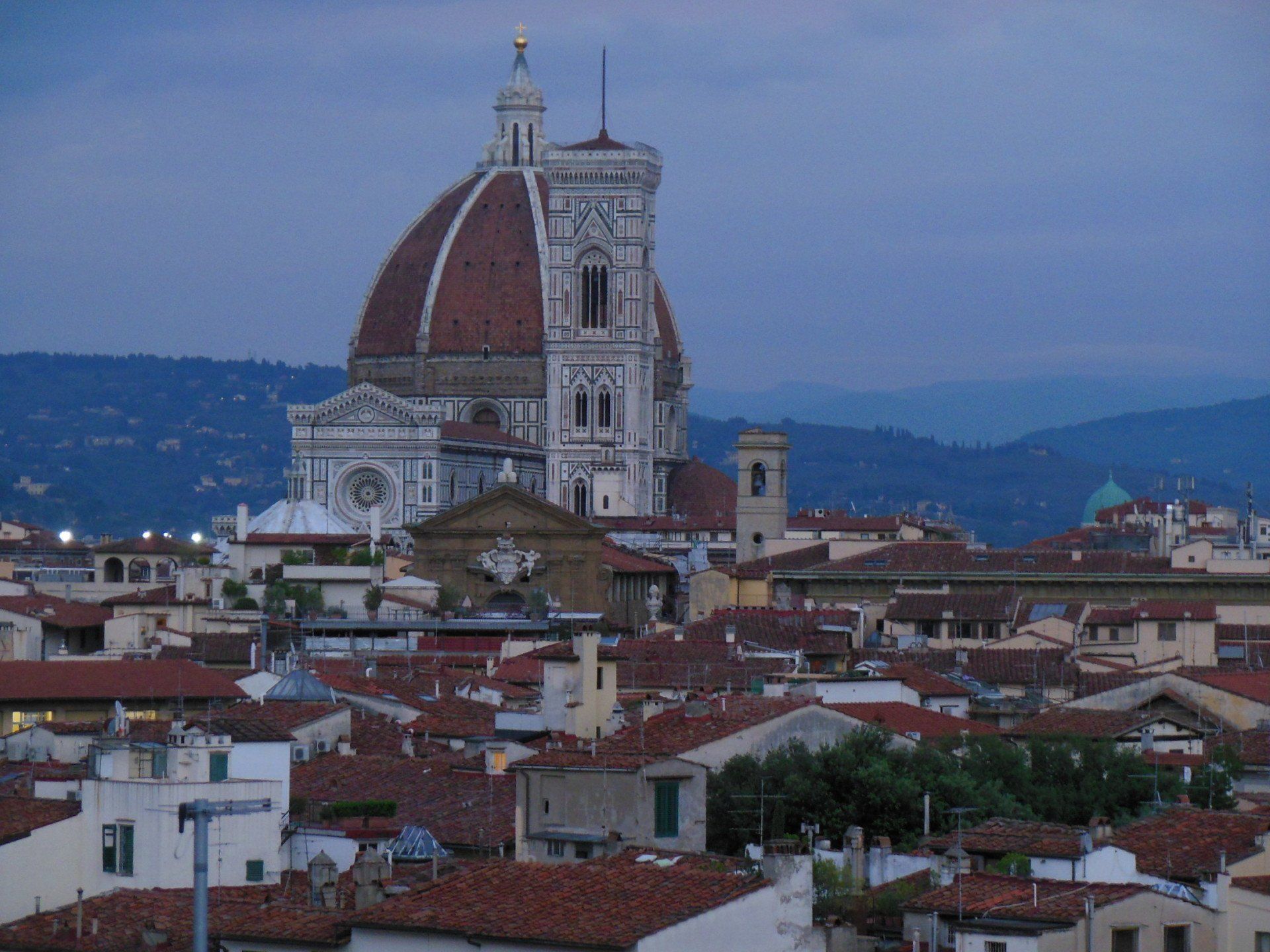 A cityscape with a large dome in the background