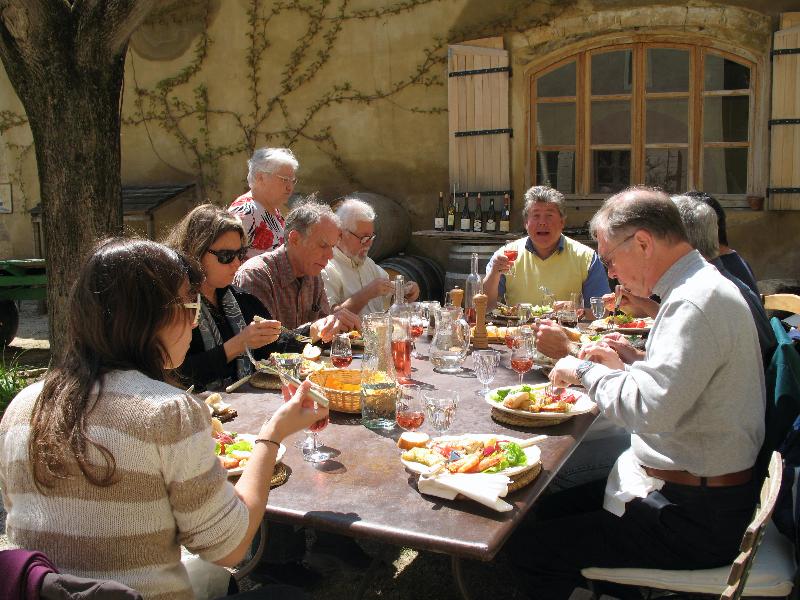 A group of people are sitting around a table eating food