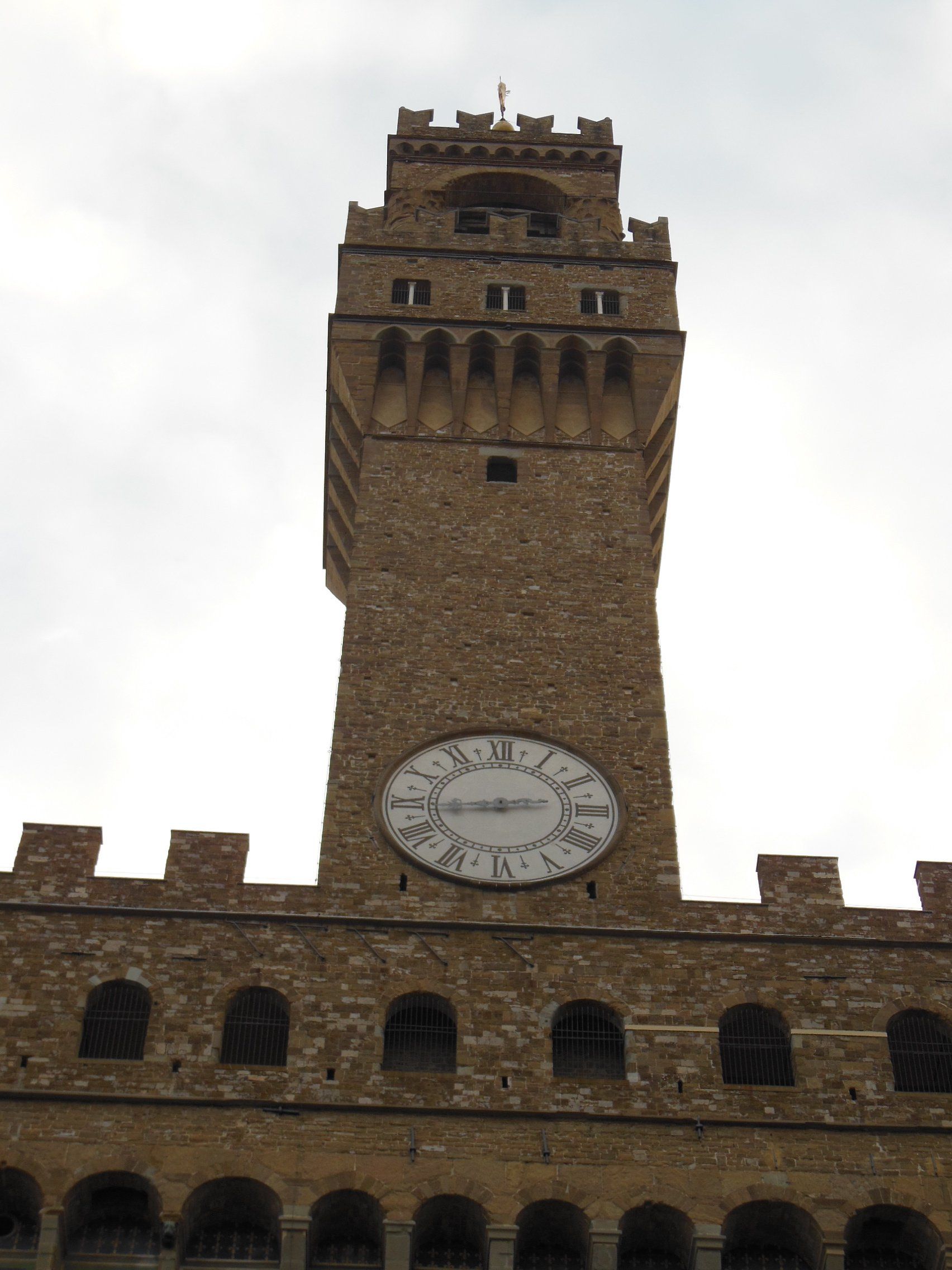 A clock on the side of a building shows the time as 4:20
