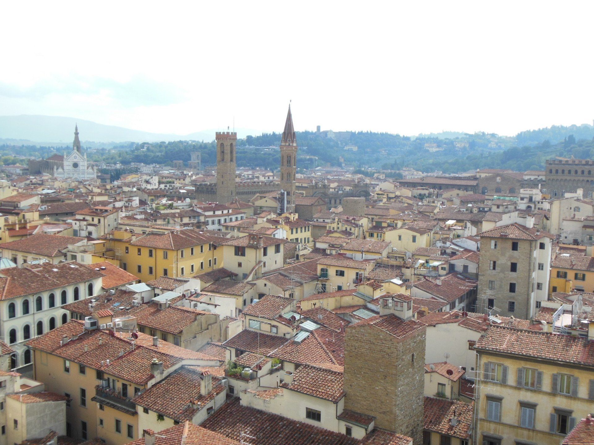 An aerial view of a city with a lot of buildings and roofs