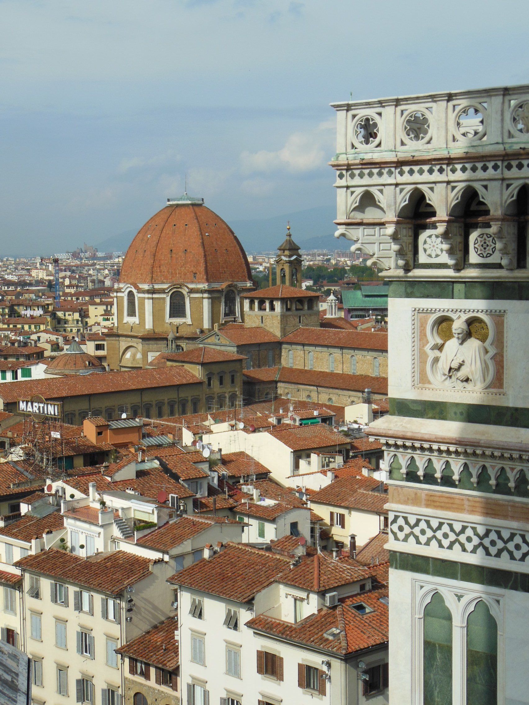 An aerial view of a city with a clock tower in the foreground