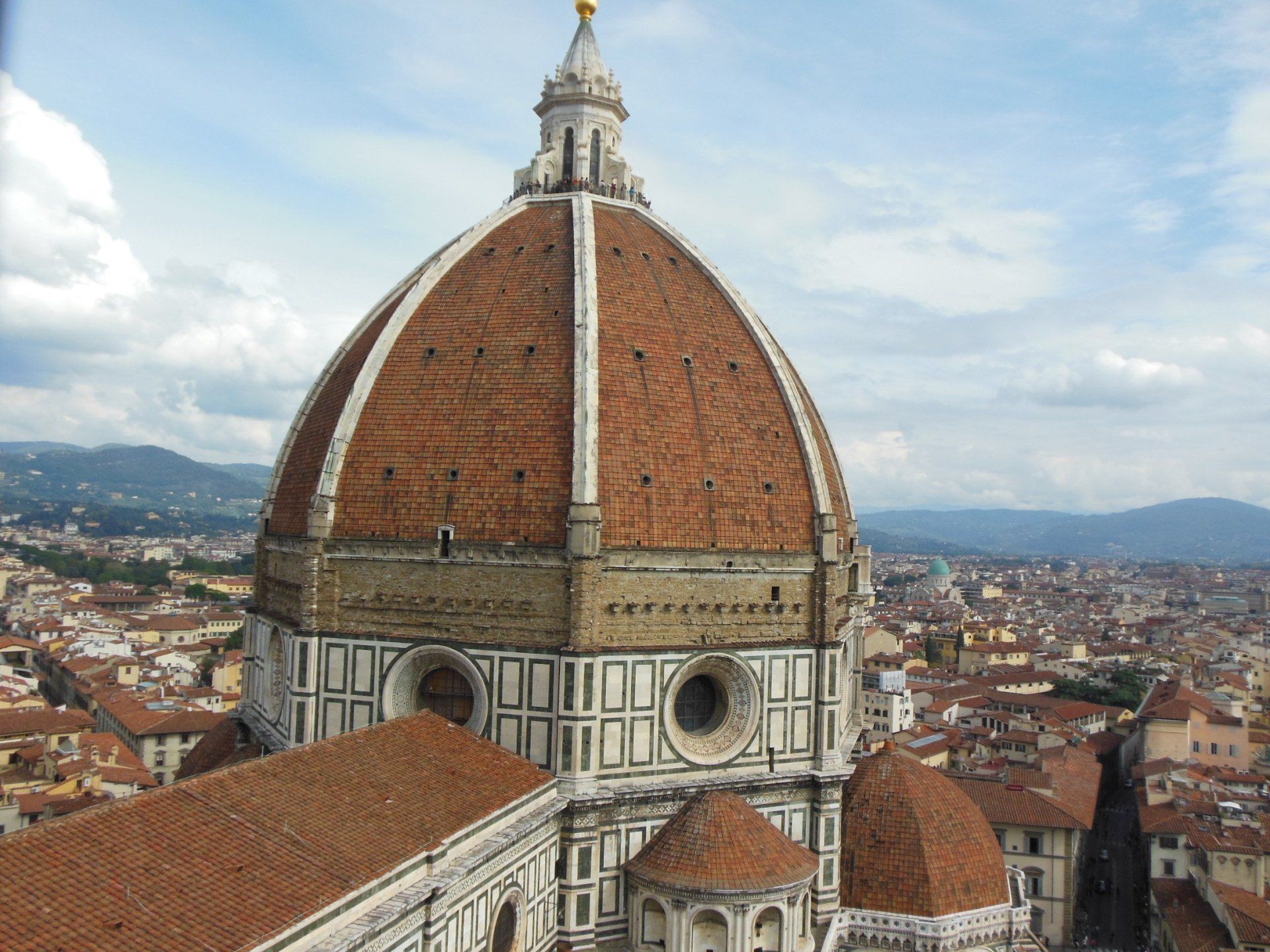 A dome shaped building with a city in the background