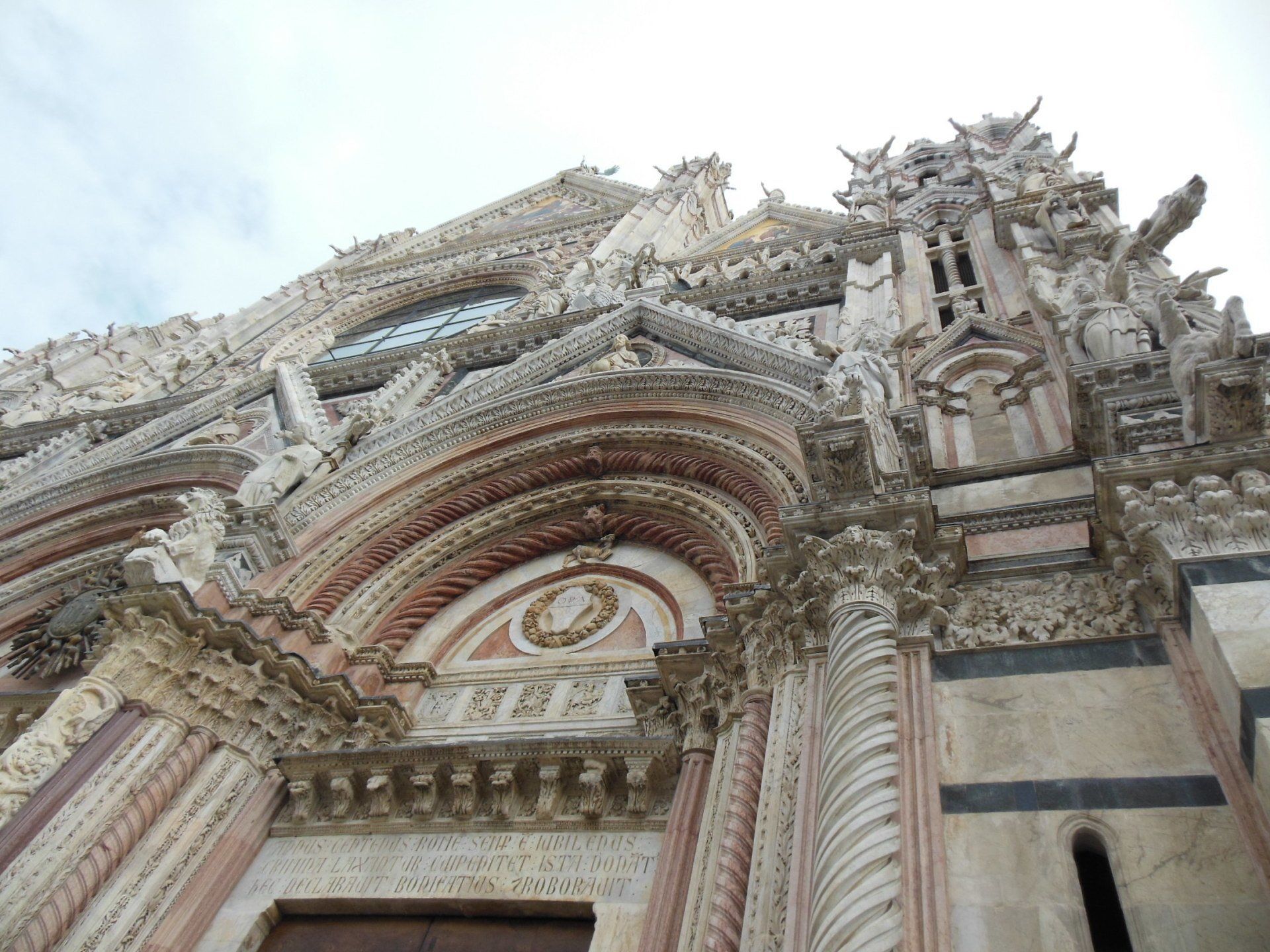 Looking up at the front of a building with a clock on it