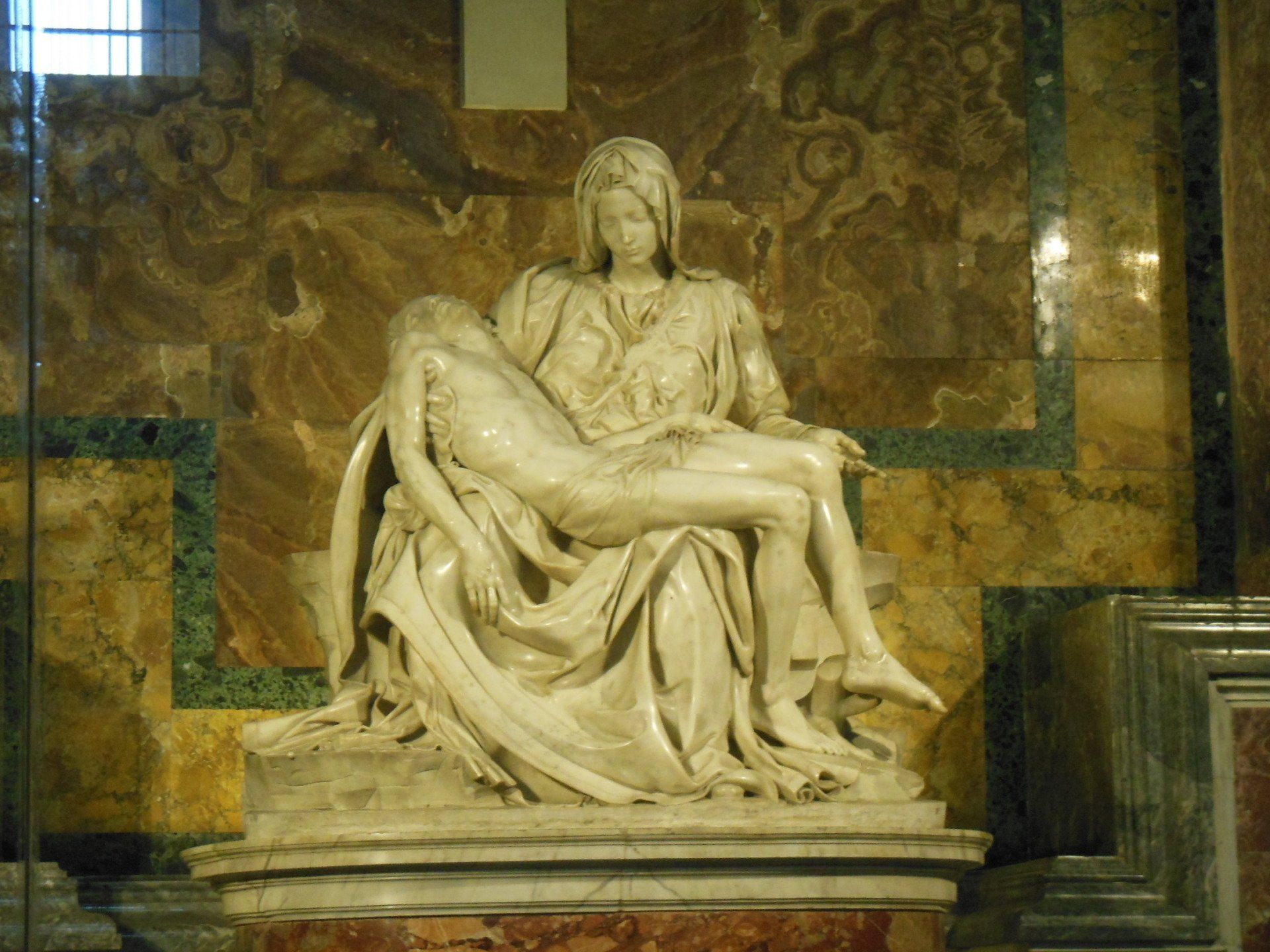 A statue of a woman holding a corpse of jesus in a church.