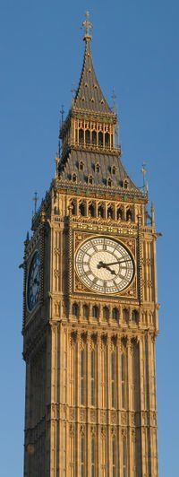 A clock tower with a blue sky in the background