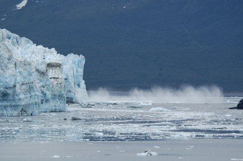 A large iceberg in the middle of a body of water