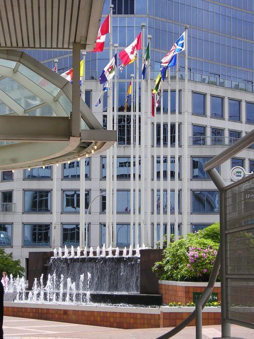 Several flags are flying in front of a building
