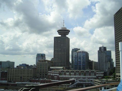 A city skyline with a very tall building in the foreground