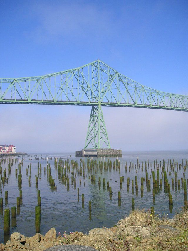 A large green bridge over a body of water