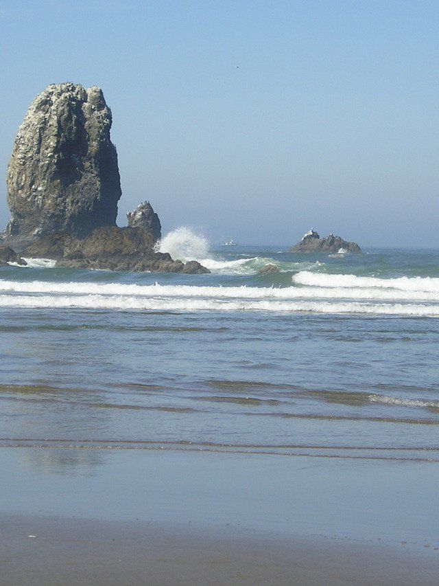 A large rock in the middle of the ocean