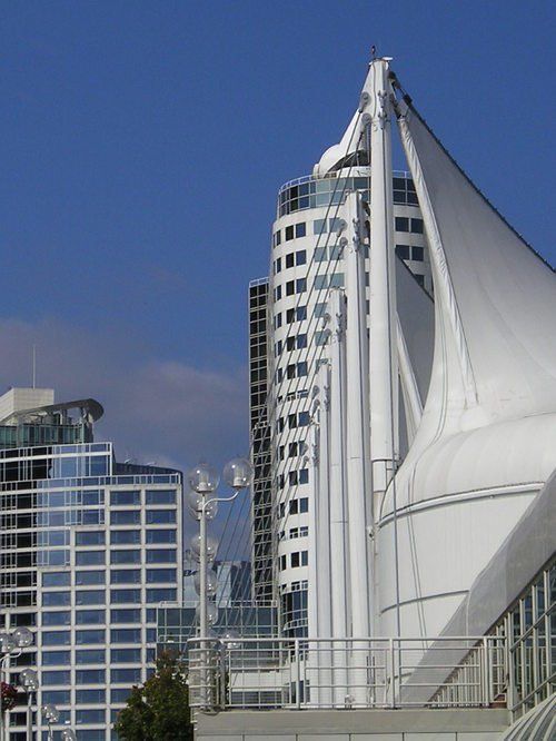A very tall building with a sail on top of it