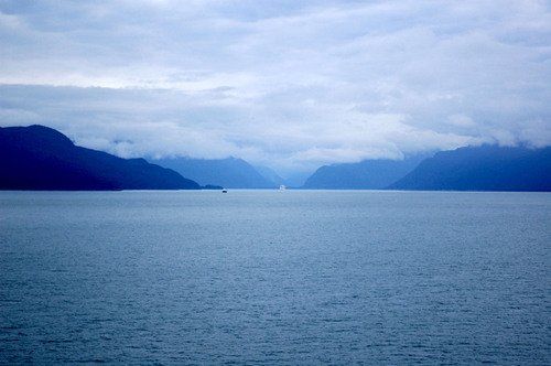 A large body of water with mountains in the background