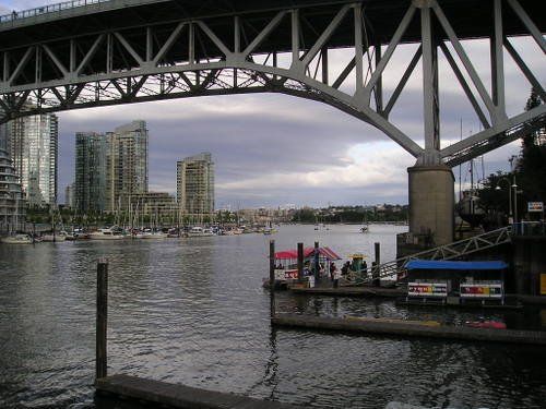 A bridge over a body of water with a dock in the foreground