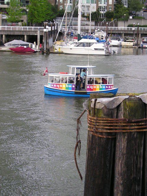 A rainbow colored boat is floating on a body of water