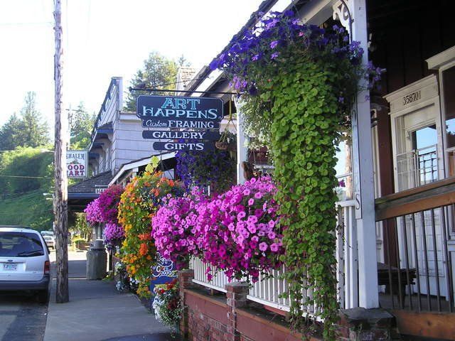 A sign for art happens hangs from a building