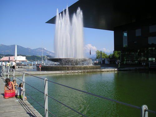 A fountain is surrounded by a large body of water