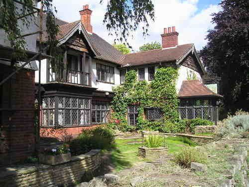 A large house with a large garden in front of it.