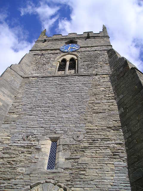 Looking up at the clock tower of a church