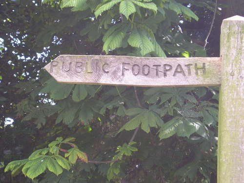 A wooden sign that says public footpath on it