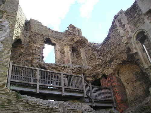 A very old building with a balcony in the middle of it.