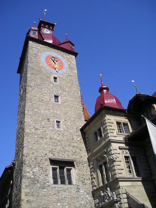 A large stone tower with a clock on top of it