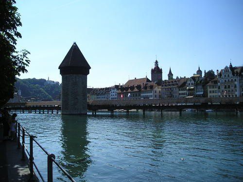 A bridge over a body of water with buildings in the background