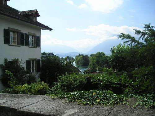 A house with a view of a river and mountains in the background