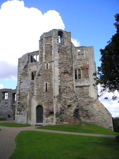 A large stone building with a blue sky in the background
