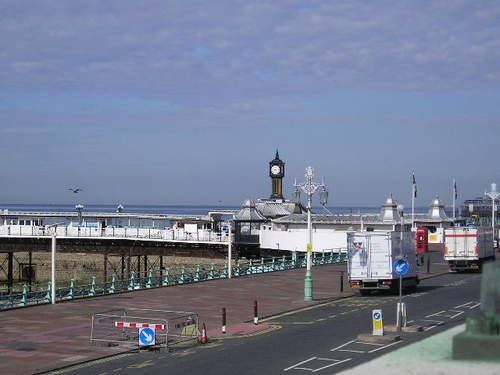 A view of a pier with a clock on top of it