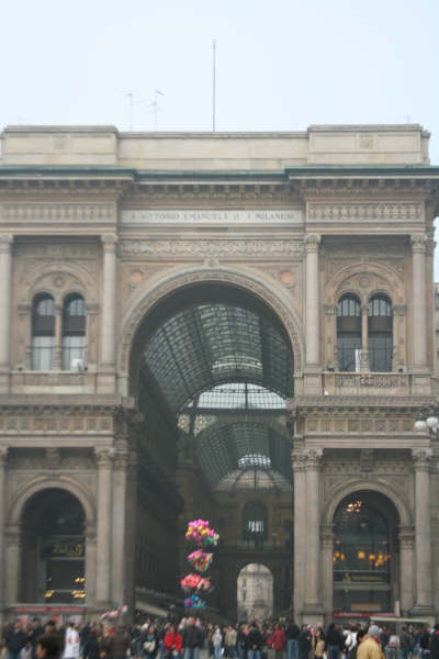 A crowd of people are gathered in front of a large building