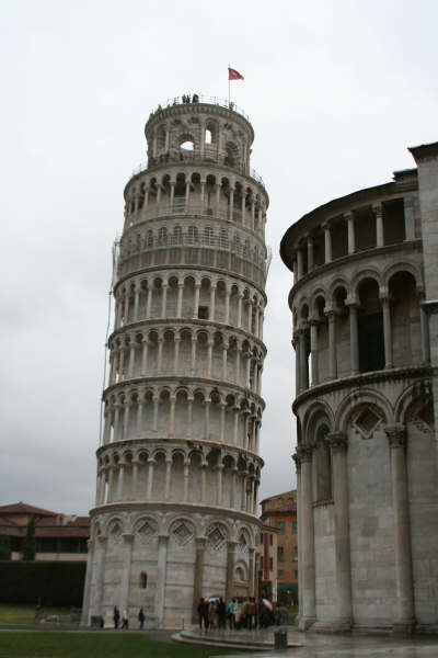 A very tall tower with a flag on top of it