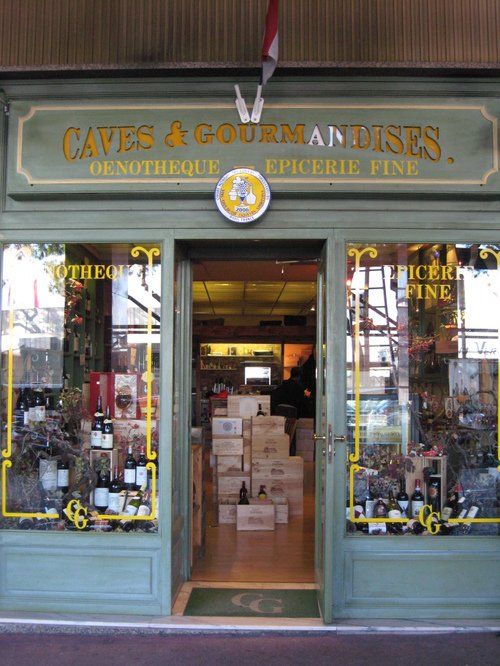 A store front with a sign that says caves & gourmandises