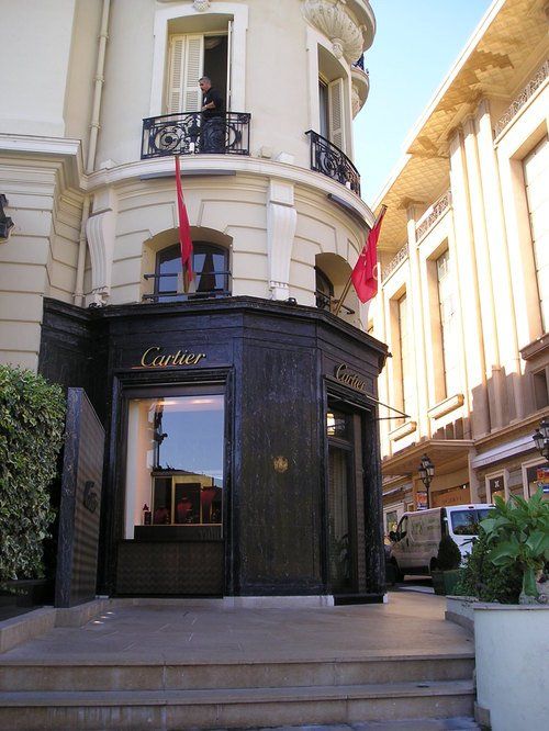 A cartier store is on the corner of a building