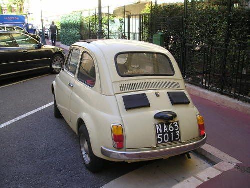 A small white car with a license plate that says na63 5013