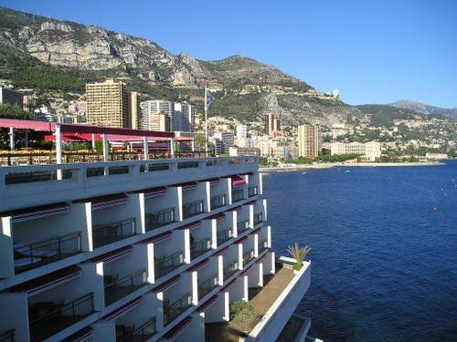 A large building with balconies overlooking a body of water