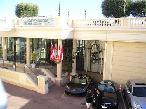 A couple of cars are parked in front of a building