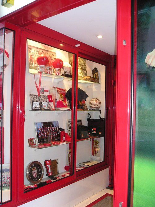 A display case with a picture of a soccer player in the background